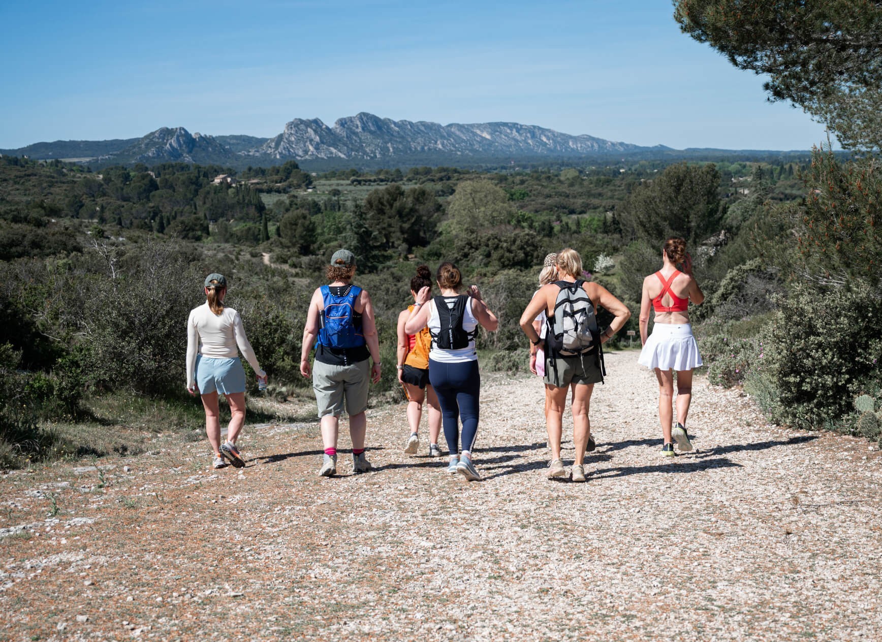 Four women walk in the countryside on an Avandra Escapes retreat day